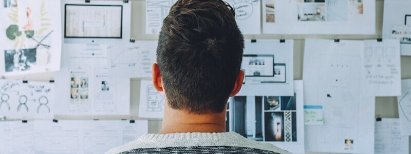 Someone looking at plans on a wall