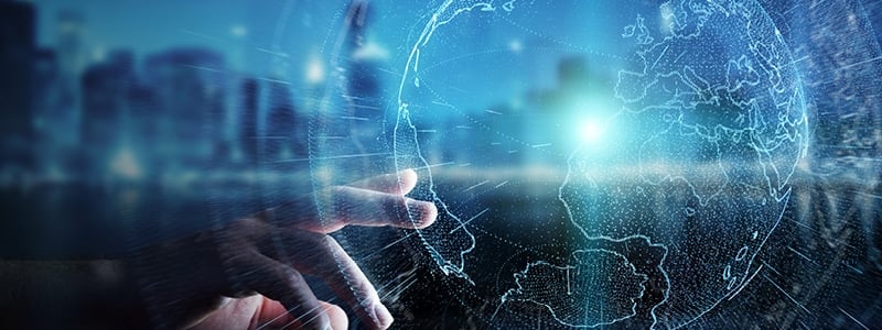 A hand touching a digital globe