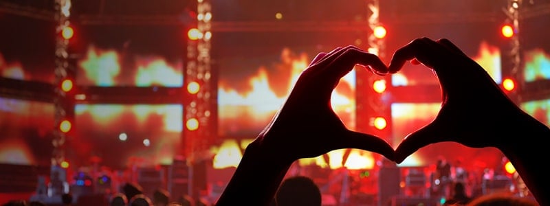 A heart shape made my hands at an event