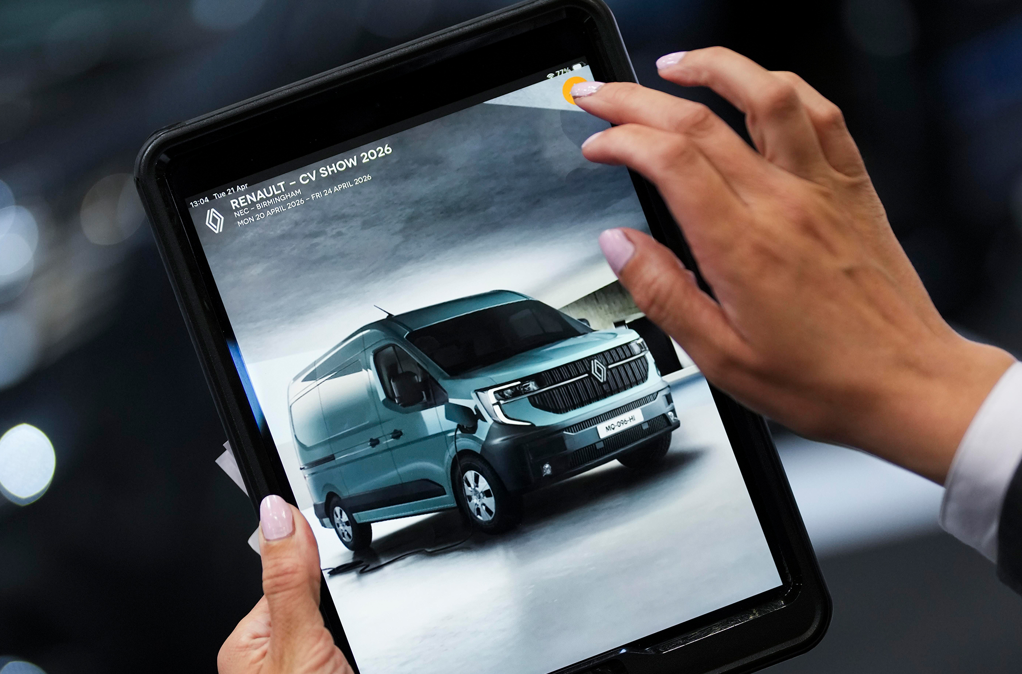 Someone at an event looking at a Renault van on an iPad